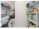 Walk-in pantry with lots of items stored and organized in multiple shelves at 7220 Nw 83 Ter, Ocala, FL 34482