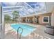 A screened in pool with a view of the pasture and the barn at 7220 Nw 83 Ter, Ocala, FL 34482