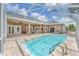 A screened in pool with chairs and tables around the outside at 7220 Nw 83 Ter, Ocala, FL 34482