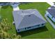 An aerial view of a spacious house featuring modern roofing and a lush green lawn perfect for outdoor activities at 7364 Sw 133 Ne Loop, Ocala, FL 34473
