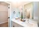 Elegant bathroom featuring a dual sink vanity, modern fixtures, and a walk-in closet at 7364 Sw 133 Ne Loop, Ocala, FL 34473