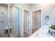 Modern bathroom with a glass-enclosed shower, dual vanity sinks, and a walk-in closet entrance at 7364 Sw 133 Ne Loop, Ocala, FL 34473