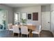 Stylish dining area with a modern table set, complemented by contemporary artwork and neutral tones at 7364 Sw 133 Ne Loop, Ocala, FL 34473