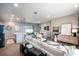 Bright, open-concept living room featuring contemporary decor, wood-look tile floors and abundant natural light at 7364 Sw 133 Ne Loop, Ocala, FL 34473