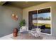 Charming patio featuring stylish seating, decorative wall art, and a sliding glass door offering serene outdoor views at 7364 Sw 133 Ne Loop, Ocala, FL 34473