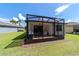 A spacious screened patio with brick pavers complements the home's lush, green backyard at 7707 Sw 94Th Cir, Ocala, FL 34481