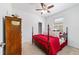 Bright bedroom with ceiling fan, carpet floors, natural light, and a vintage dresser at 7707 Sw 94Th Cir, Ocala, FL 34481
