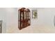 Elegant dining room with ornate china cabinet, tile floors, and natural light at 7707 Sw 94Th Cir, Ocala, FL 34481