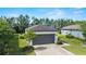 Home with a neutral palette has a 2-car garage, well-maintained landscaping, and inviting entrance at 7707 Sw 94Th Cir, Ocala, FL 34481