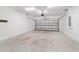 Spacious two car garage with sealed concrete floors and overhead lighting at 7707 Sw 94Th Cir, Ocala, FL 34481