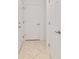 Hallway with tile floors and multiple doors at 7707 Sw 94Th Cir, Ocala, FL 34481