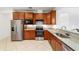 Traditional kitchen with granite countertops, stainless steel appliances, and wood cabinetry at 7707 Sw 94Th Cir, Ocala, FL 34481