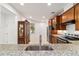 Modern kitchen featuring granite countertops, wooden cabinetry, and stainless steel appliances at 7707 Sw 94Th Cir, Ocala, FL 34481