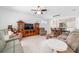 Spacious living room features tile floors, a ceiling fan, and access to a dining area at 7707 Sw 94Th Cir, Ocala, FL 34481