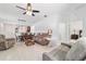 Spacious living room features tile floors, a ceiling fan, and access to a dining area at 7707 Sw 94Th Cir, Ocala, FL 34481