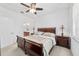Spacious main bedroom with neutral tones, ceiling fan, and ensuite bathroom at 7707 Sw 94Th Cir, Ocala, FL 34481