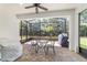 Screened patio area featuring brick floors and a table at 7707 Sw 94Th Cir, Ocala, FL 34481