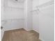 Spacious walk-in closet with carpet flooring and multiple rows of wire shelving for optimal storage space at 7707 Sw 94Th Cir, Ocala, FL 34481