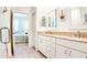 Bathroom with granite counters, double sinks, glass enclosed shower and wood look floors at 7765 Sw 86Th Loop, Ocala, FL 34476