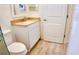 Clean bathroom featuring a white vanity with granite countertop and wood-look tile flooring at 7765 Sw 86Th Loop, Ocala, FL 34476