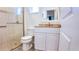 Bathroom with a glass enclosed shower, white vanity with granite countertop, and tile flooring at 7765 Sw 86Th Loop, Ocala, FL 34476