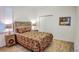 Charming bedroom with unique wooden headboard, paisley bedding, and bright natural lighting at 7765 Sw 86Th Loop, Ocala, FL 34476