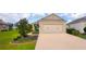 Beautiful home with a two car garage, mature landscaping, and a well-maintained driveway at 7765 Sw 86Th Loop, Ocala, FL 34476