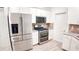 Well-lit kitchen with stainless steel appliances and tile backsplash with great storage space at 7765 Sw 86Th Loop, Ocala, FL 34476