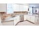 The kitchen offers white cabinets, stainless steel appliances, tile backsplash, and granite countertops at 7765 Sw 86Th Loop, Ocala, FL 34476