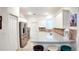 Well-lit kitchen with stainless steel appliances, granite countertops, tile backsplash, and seating at the breakfast bar at 7765 Sw 86Th Loop, Ocala, FL 34476