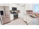 Well-lit kitchen with stainless steel appliances, tile backsplash, and granite countertops at 7765 Sw 86Th Loop, Ocala, FL 34476