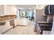 Modern kitchen featuring stainless steel appliances, granite countertops, and white cabinets and an open view to the living room at 7765 Sw 86Th Loop, Ocala, FL 34476