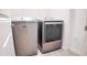 Laundry room showcasing a new, gray Maytag washer and dryer set on a wood-look tile floor at 7765 Sw 86Th Loop, Ocala, FL 34476
