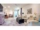 Open-concept living room with lots of natural light, neutral paint, ceiling fan and modern decor at 7765 Sw 86Th Loop, Ocala, FL 34476