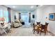 Bright living room featuring hardwood floors, comfortable seating, and sliding glass doors to the screened lanai at 7765 Sw 86Th Loop, Ocala, FL 34476
