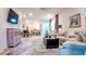 Open-concept living room with lots of natural light, neutral paint, ceiling fan and modern decor at 7765 Sw 86Th Loop, Ocala, FL 34476