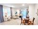 Bright living room featuring hardwood floors, comfortable seating, and sliding glass doors to the screened lanai at 7765 Sw 86Th Loop, Ocala, FL 34476
