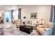 Open-concept living room with lots of natural light, neutral paint, ceiling fan and modern decor at 7765 Sw 86Th Loop, Ocala, FL 34476