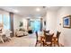 Open floor plan with living, dining, and workspace; neutral tones, natural light, and comfortable seating at 7765 Sw 86Th Loop, Ocala, FL 34476