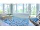 Bright sunroom with lots of natural light from the large windows, a stylish rug, and cozy furniture at 7765 Sw 86Th Loop, Ocala, FL 34476