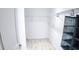 Organized walk-in closet with wood-look floors and ample shelving for storage at 7765 Sw 86Th Loop, Ocala, FL 34476