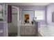 Bathroom featuring a tub and shower, a window, and vanity storage at 8187 Sw 60Th Ter, Ocala, FL 34476