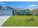 Charming single story home featuring a well-manicured front lawn, landscaped garden beds, and a two-car garage at 8187 Sw 60Th Ter, Ocala, FL 34476