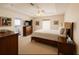 Spacious main bedroom featuring tray ceilings, a ceiling fan, and an en-suite bathroom with tub at 8187 Sw 60Th Ter, Ocala, FL 34476
