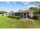 Spacious backyard featuring a screened patio and well-maintained lawn, ideal for outdoor living at 8677 Sw 95Th Ln # A, Ocala, FL 34481