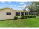 Exterior view showcases the backyard with well-manicured lawn and view of the patio at 8677 Sw 95Th Ln # A, Ocala, FL 34481