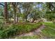 Serene backyard showcasing lush landscaping with mature trees and a well-maintained lawn at 8677 Sw 95Th Ln # A, Ocala, FL 34481