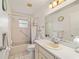 Bright bathroom features a shower-tub combo, tile flooring, and a vanity with storage at 8677 Sw 95Th Ln # A, Ocala, FL 34481