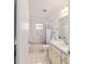 Bright bathroom features a shower-tub combo, tile flooring, and a vanity with storage at 8677 Sw 95Th Ln # A, Ocala, FL 34481