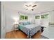 Charming bedroom with wood floors, ceiling fan, and bright windows providing natural light at 8677 Sw 95Th Ln # A, Ocala, FL 34481